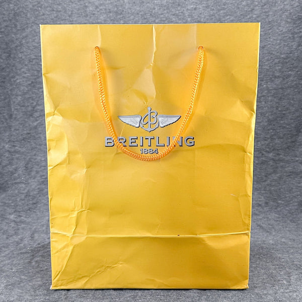 Estate Breitling Yellow Paper Bag EMPTY - Walter Bauman Jewelers